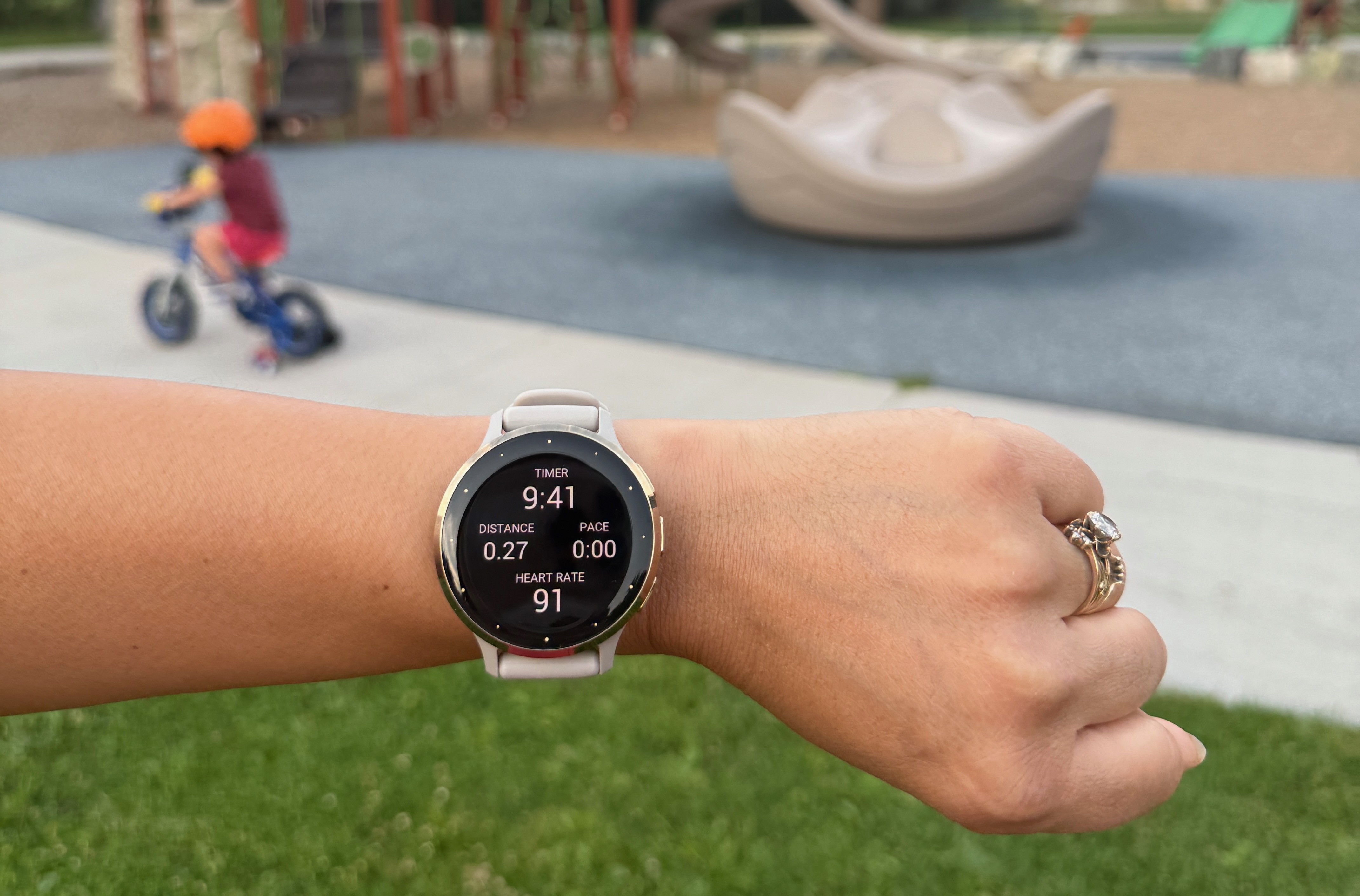 watch on wrist with kid in background