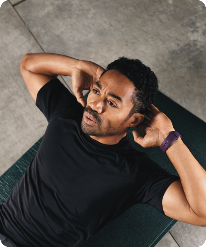 A man on a yoga mat doing crunches